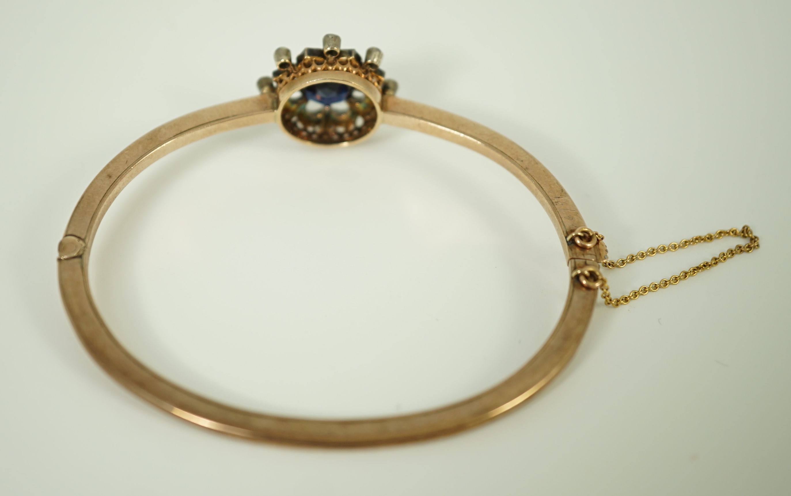 A Victorian gold, sapphire and diamond cluster set hinged bangle